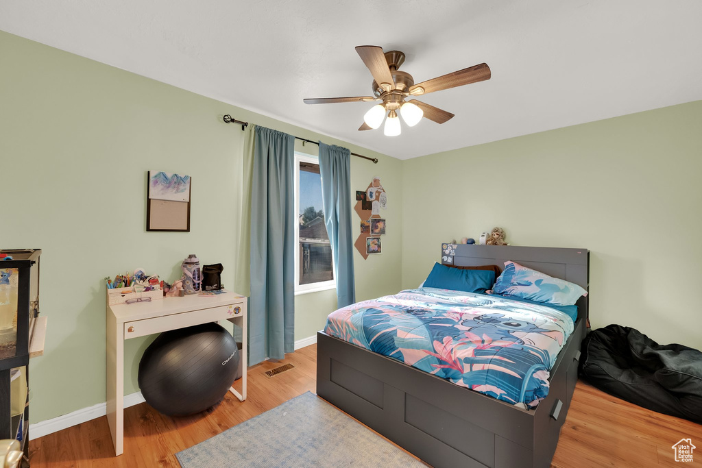 Bedroom featuring wood finished floors and ceiling fan