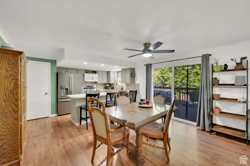 Dining area featuring ceiling fan, light wood finished floors, and recessed lighting