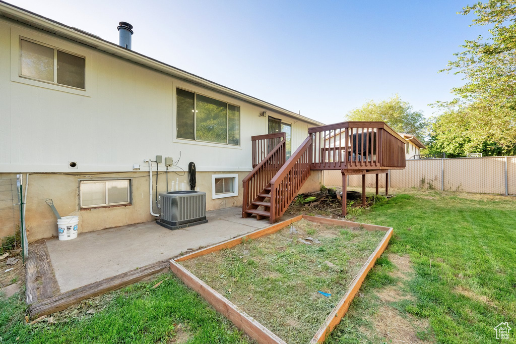 Back of property featuring a patio area, a wooden deck, and stairs