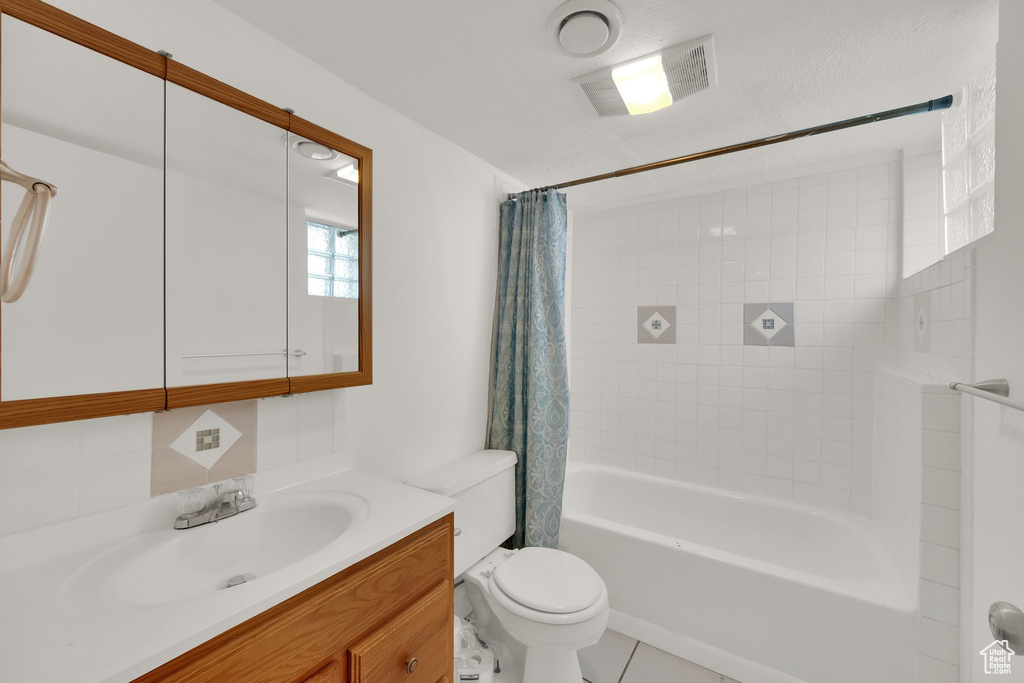 Full bathroom with vanity and shower / bath combo with shower curtain