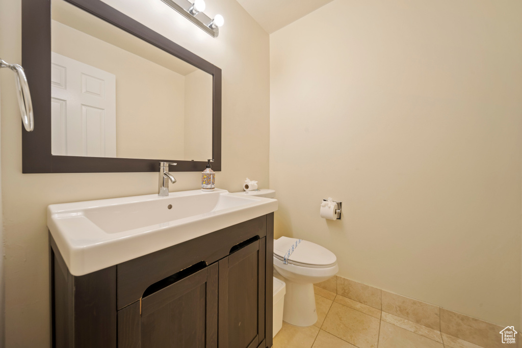 Half bath with vanity and tile patterned floors