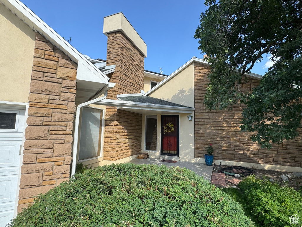 Entrance to property with stone siding