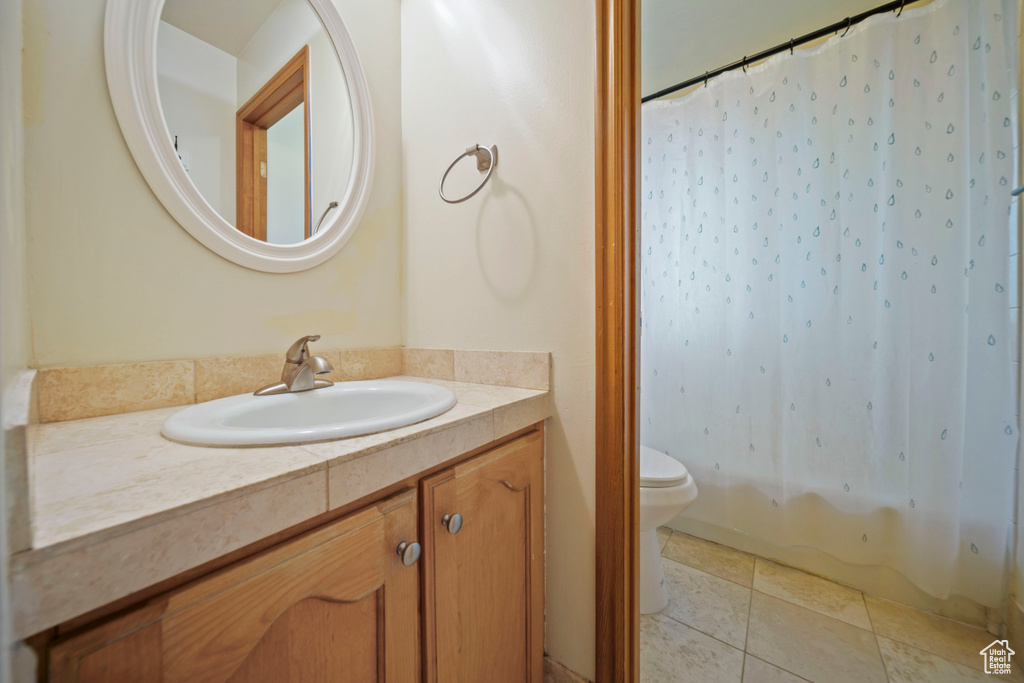 Full bathroom with vanity and tile patterned flooring
