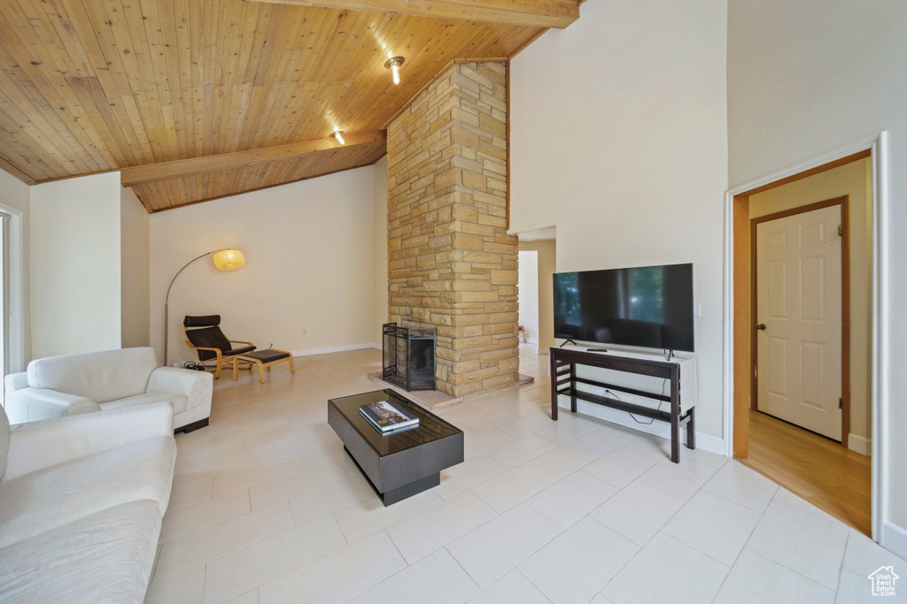 Tiled living area with wooden ceiling, high vaulted ceiling, and ornate columns