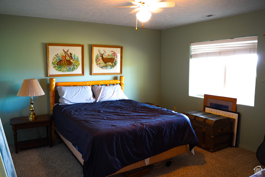 Bedroom featuring carpet flooring and a textured ceiling