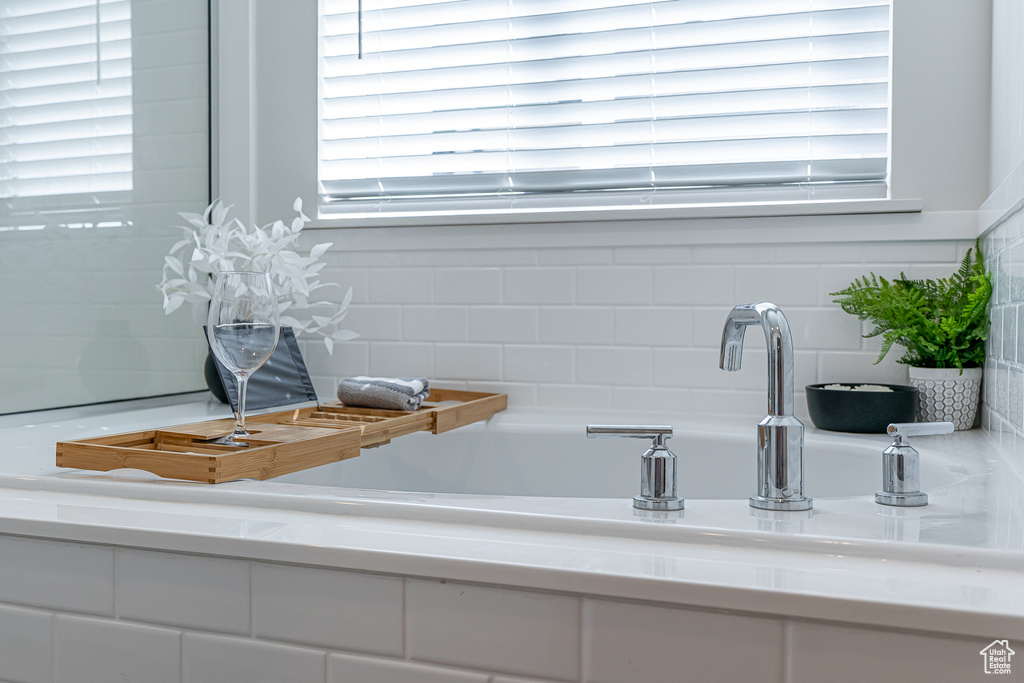 Detailed view of a bathtub and backsplash