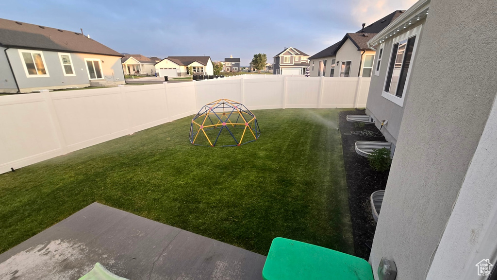 Fenced backyard featuring a residential view