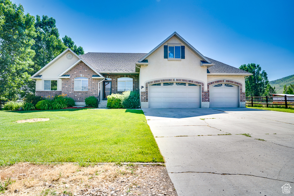 View of front of home with driveway, brick siding, an attached garage, and roof with shingles