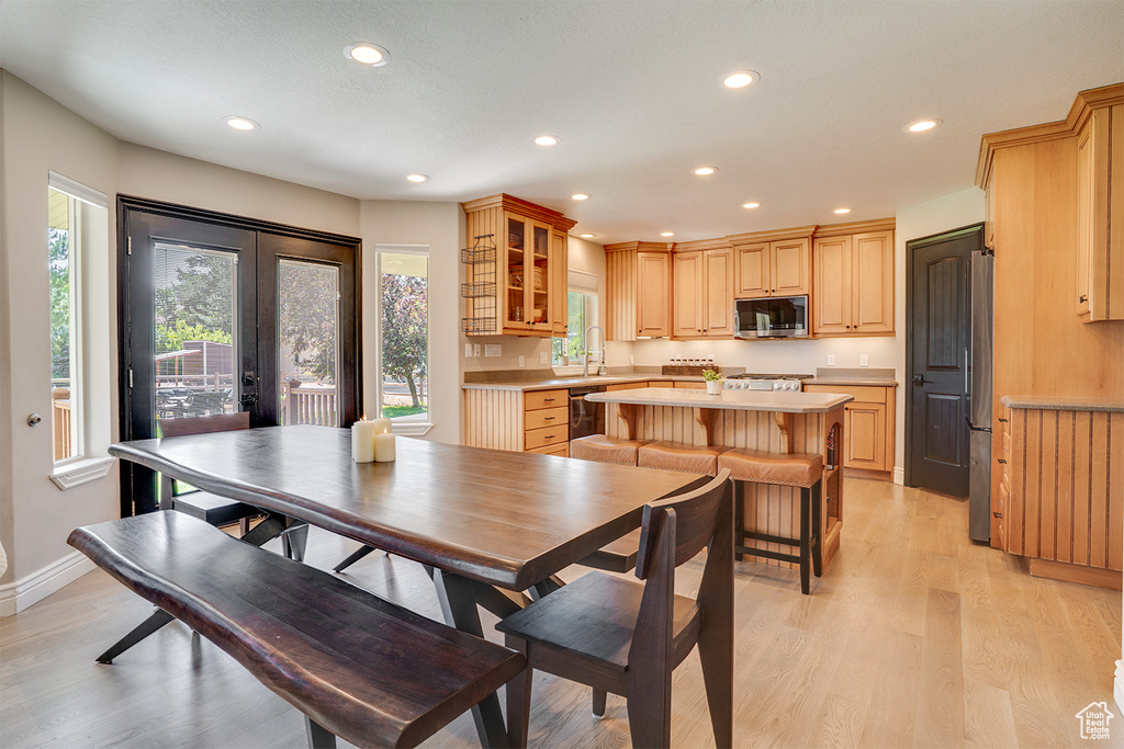Dining space featuring french doors, recessed lighting, and light wood-style flooring