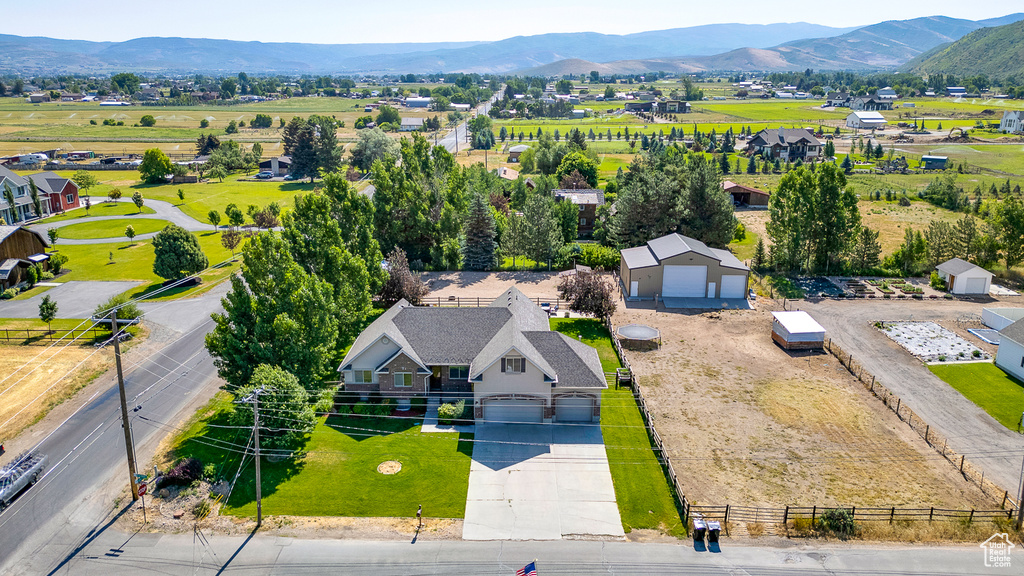 Aerial view of property and surrounding area featuring mountains