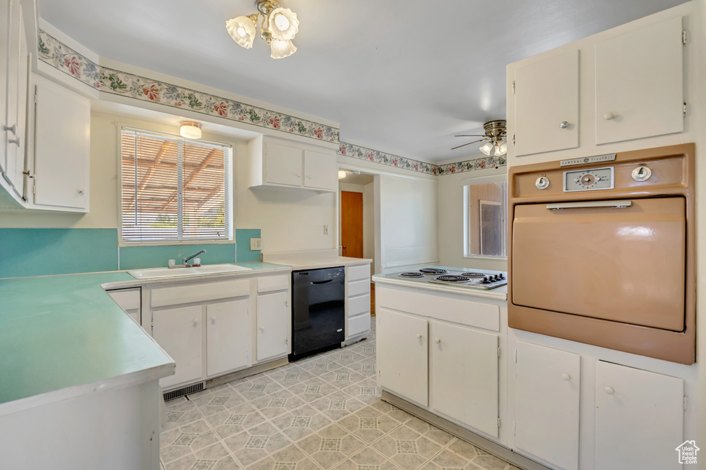 Kitchen featuring black dishwasher, wall oven, ceiling fan, and white cabinets