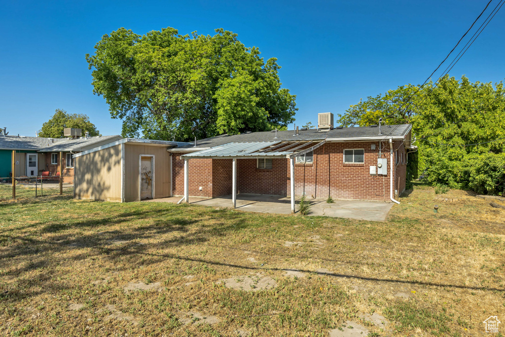 Back of house featuring a patio area and brick siding