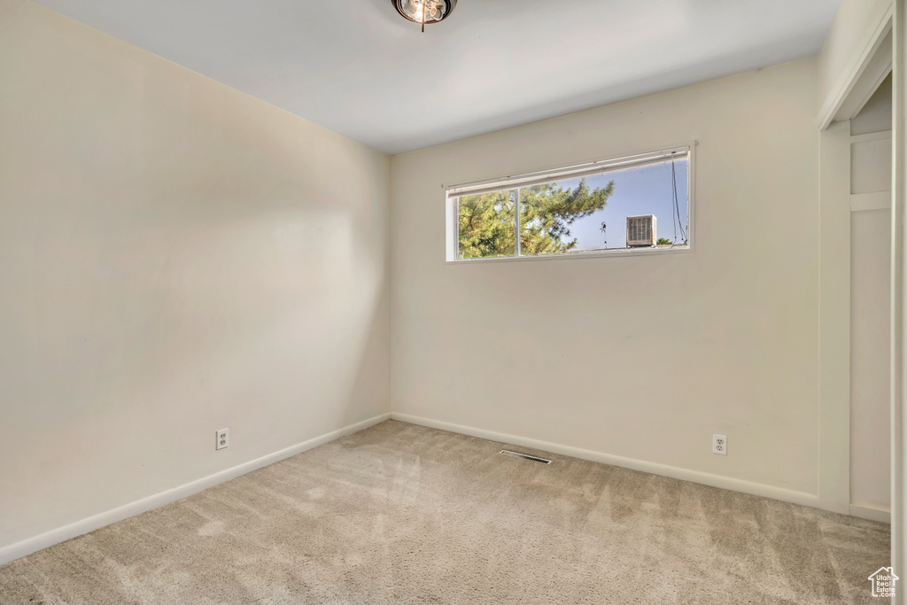 Unfurnished bedroom with carpet and baseboards
