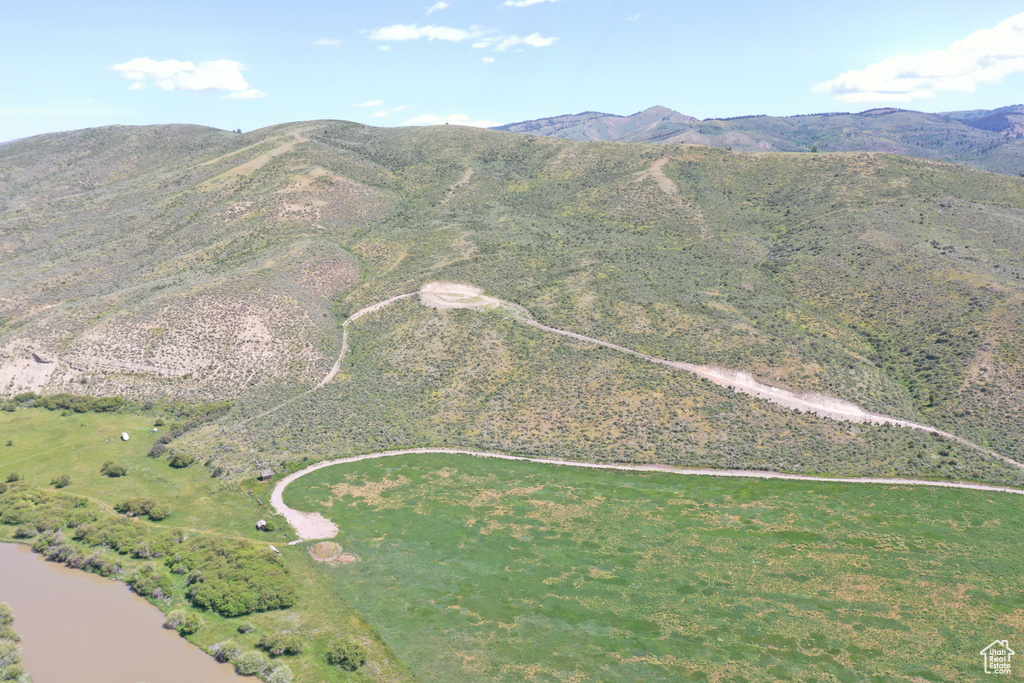 Aerial view of property and surrounding area with a mountain backdrop