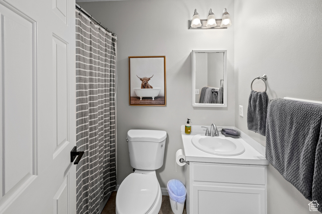 Full bath featuring vanity and toilet