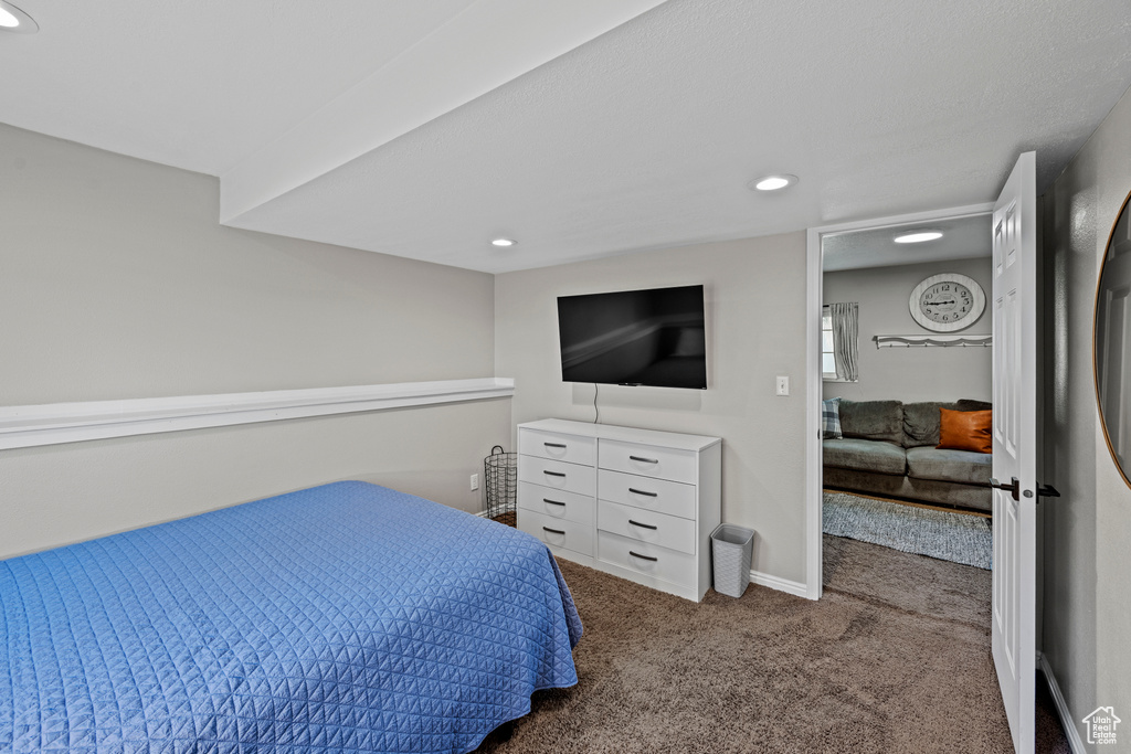 Carpeted bedroom with recessed lighting