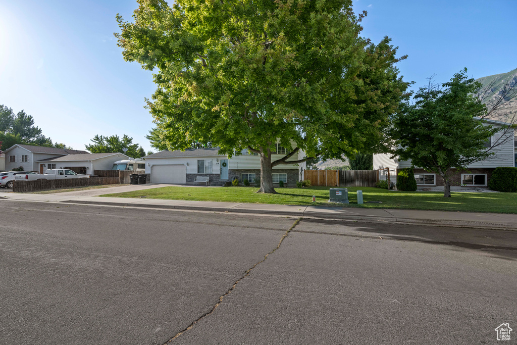 View of front facade featuring concrete driveway and an attached garage
