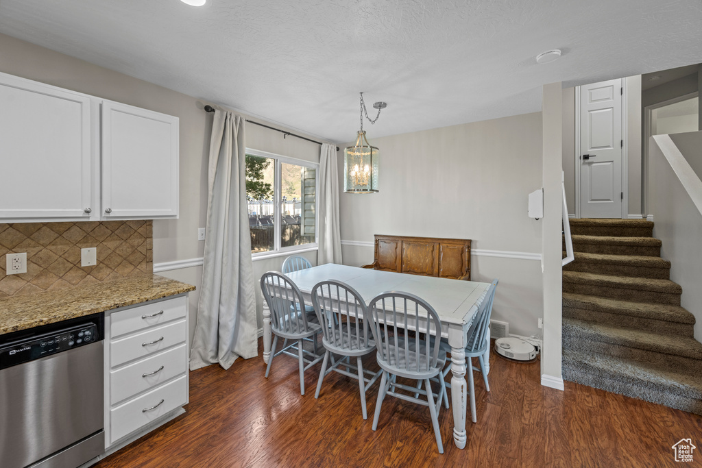Dining area with dark wood finished floors and stairway