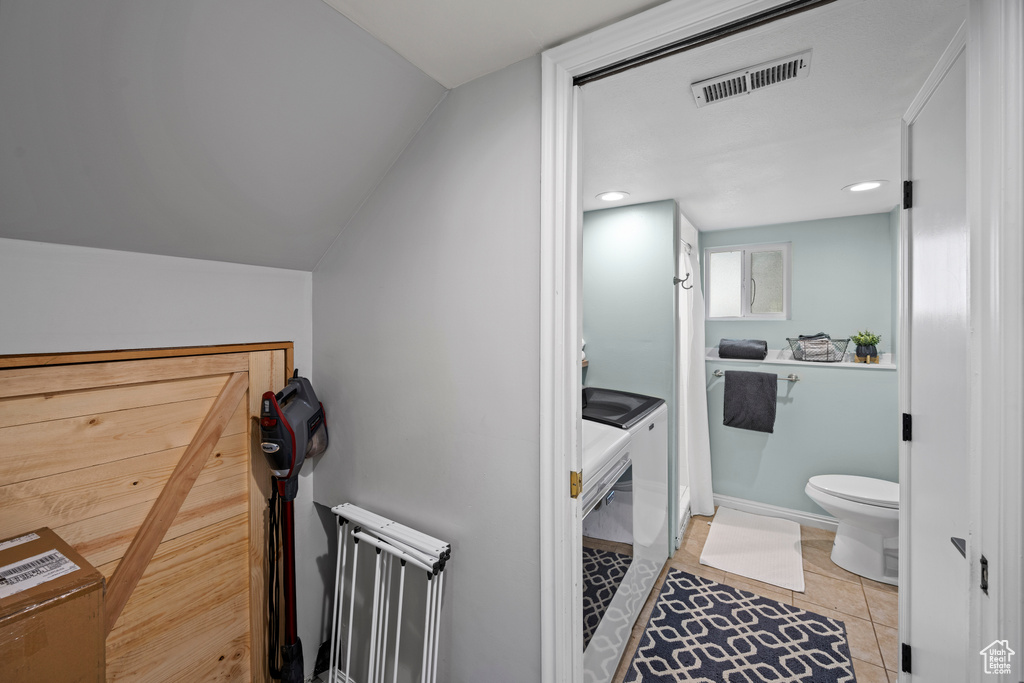Bathroom featuring washer and clothes dryer, tile patterned floors, and recessed lighting