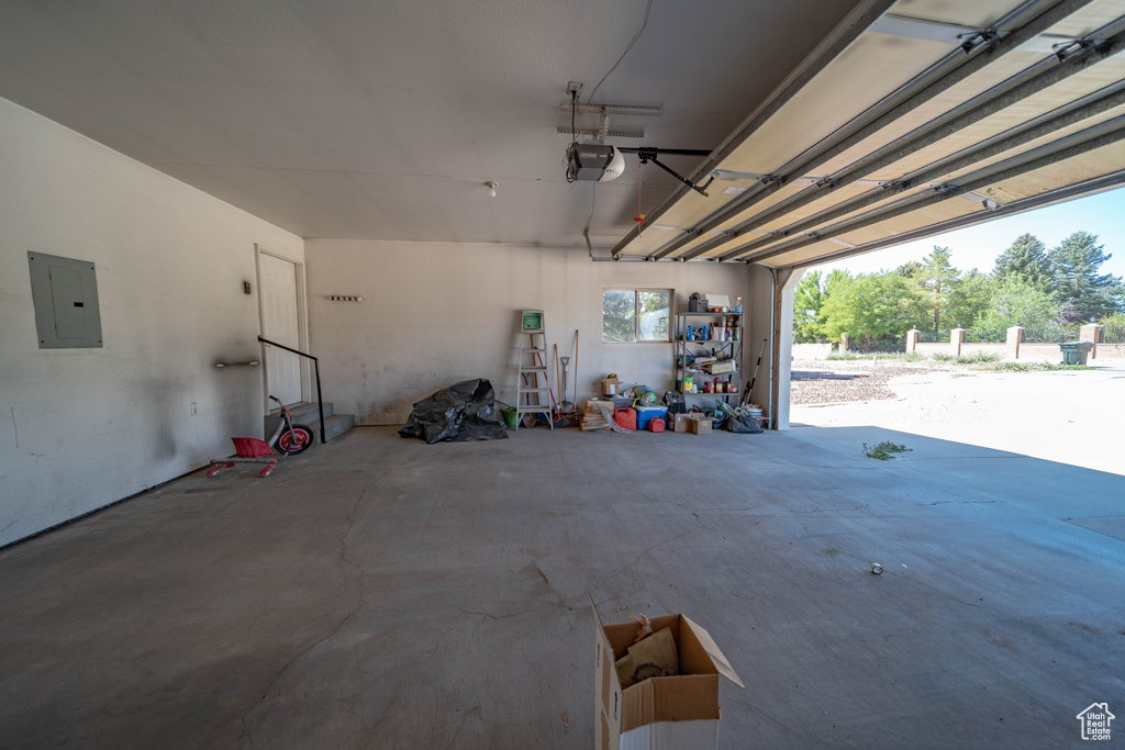 Garage with electric panel and a garage door opener
