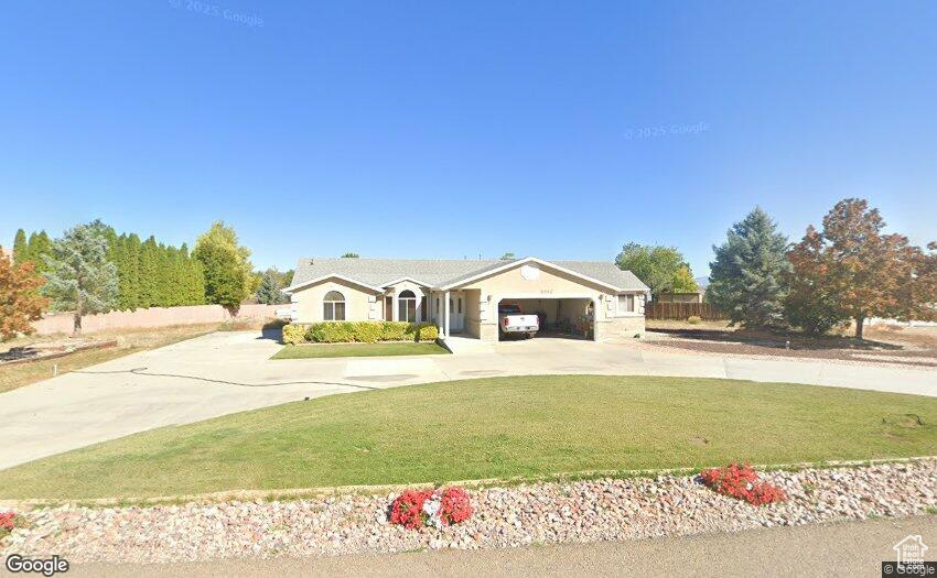 Single story home with concrete driveway and a garage