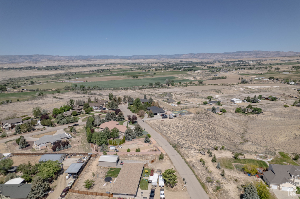 Aerial view of property and surrounding area featuring rural landscape and mountains