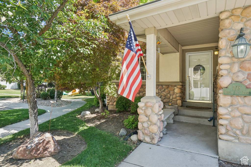 View of exterior entry featuring stone siding