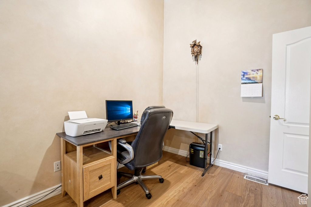 Office area featuring light wood-type flooring and baseboard heating