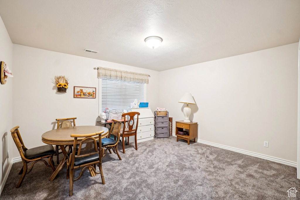 Dining area featuring carpet flooring and baseboards