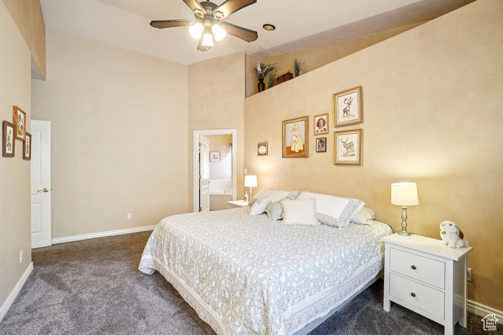 Bedroom with dark carpet and a ceiling fan