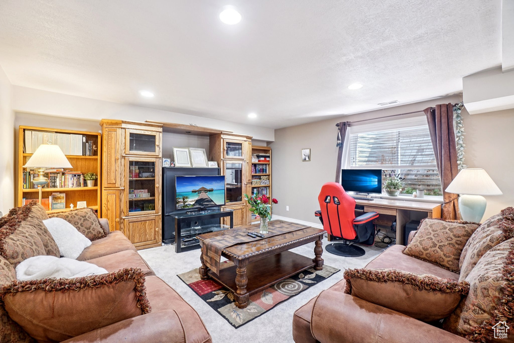 Living area with recessed lighting, a desk, and carpet flooring