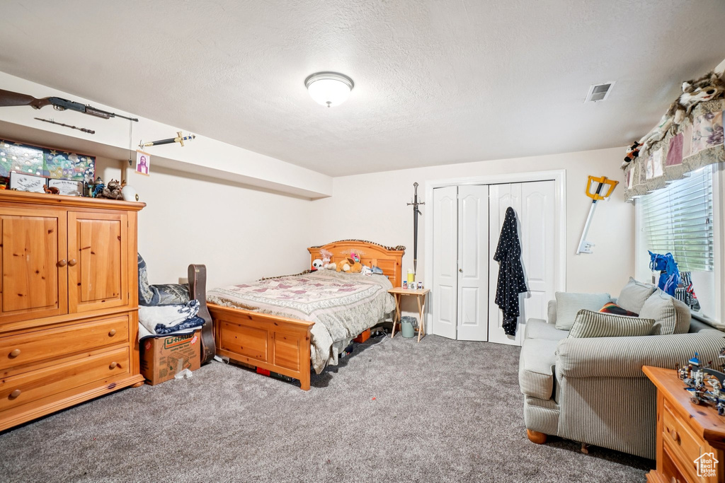 Bedroom with carpet floors and a closet