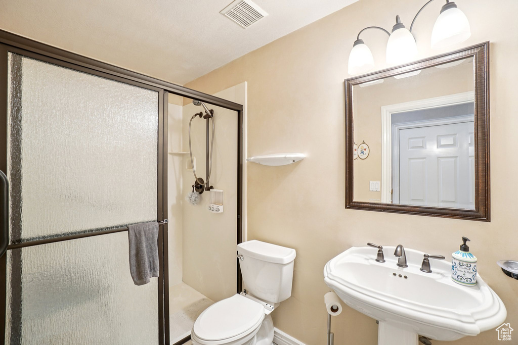 Full bath featuring a sink and a stall shower