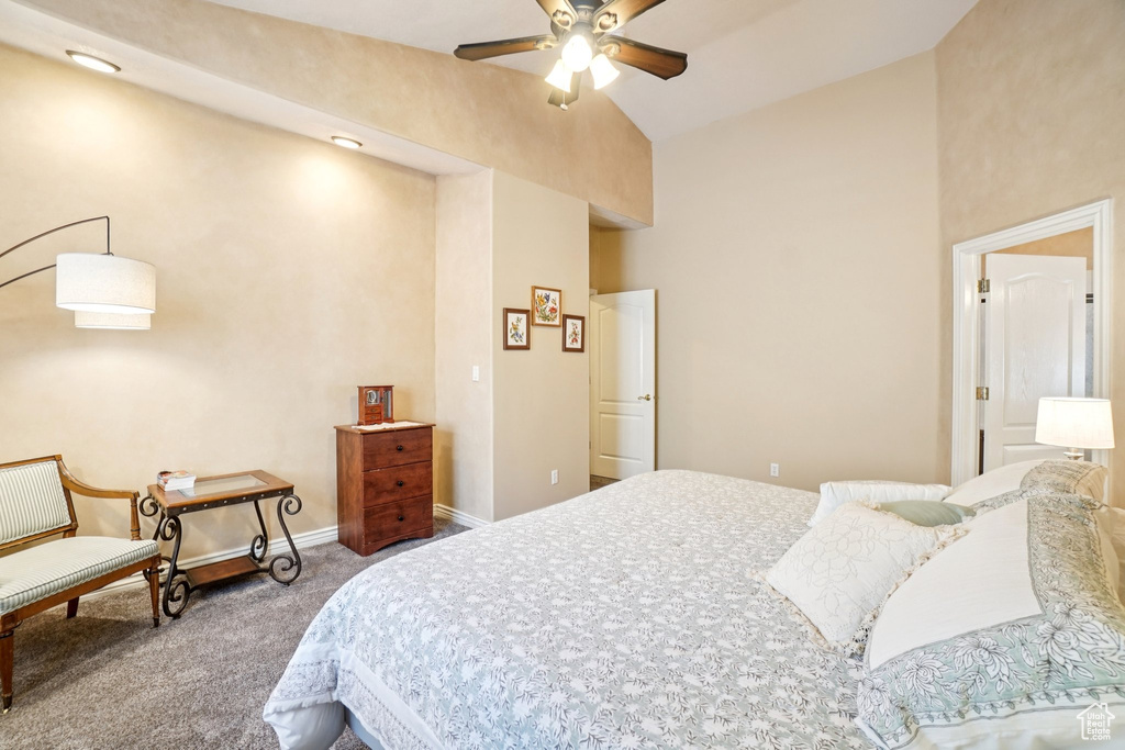 Carpeted bedroom with high vaulted ceiling and a ceiling fan