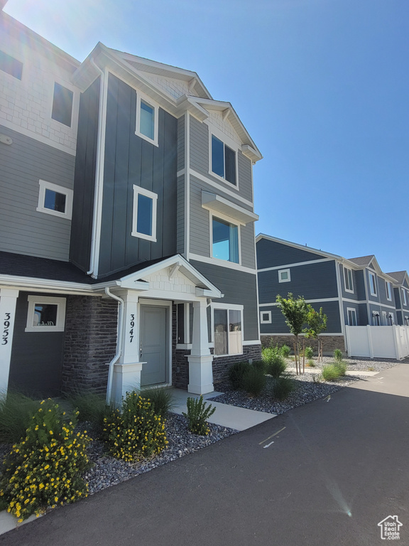 View of front of property with board and batten siding and stone siding