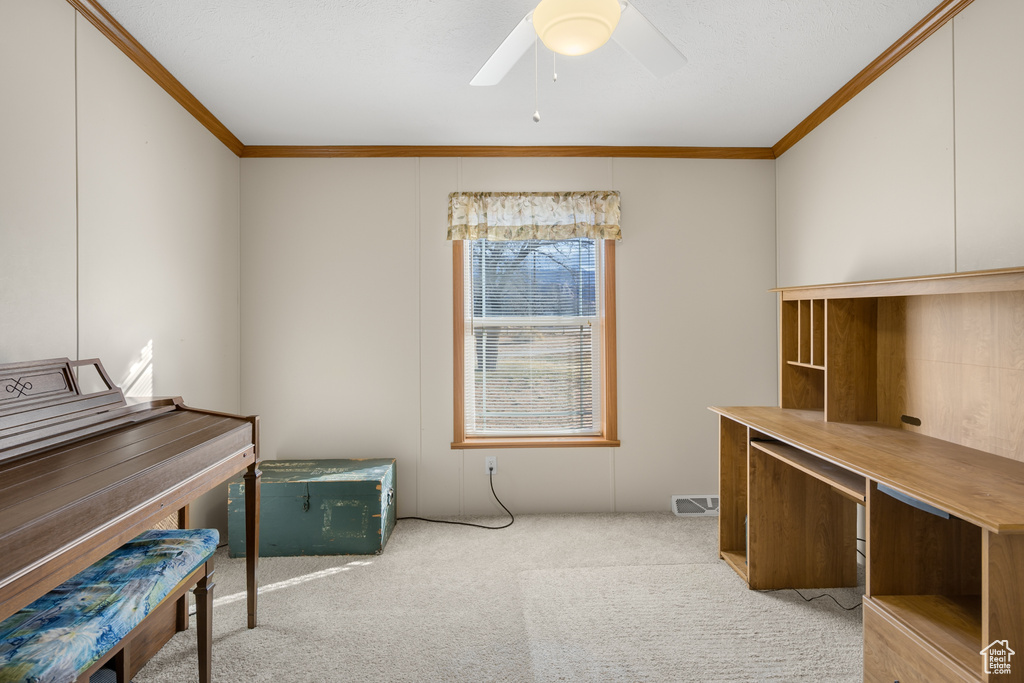 Office space with crown molding, carpet floors, and ceiling fan