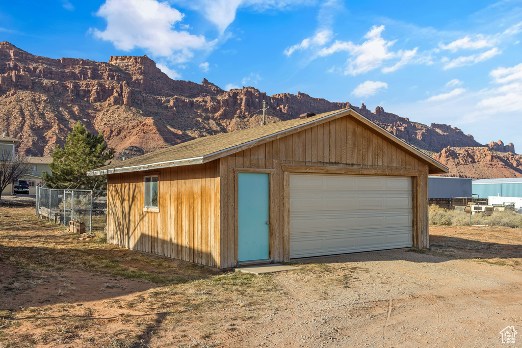 Detached garage featuring driveway and a mountain view