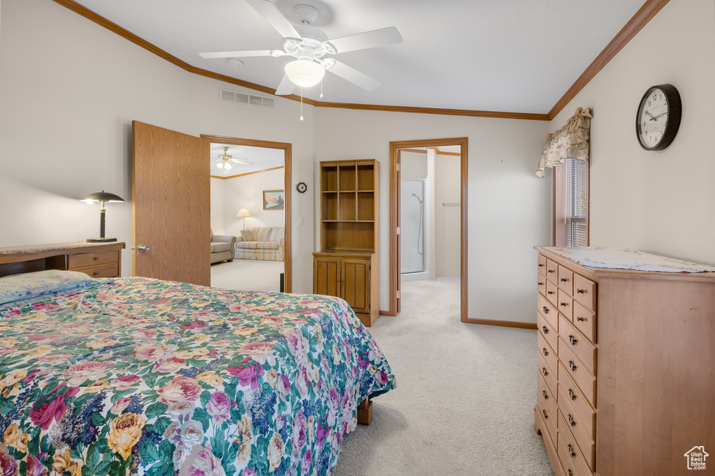 Bedroom with light colored carpet, crown molding, a ceiling fan, and vaulted ceiling