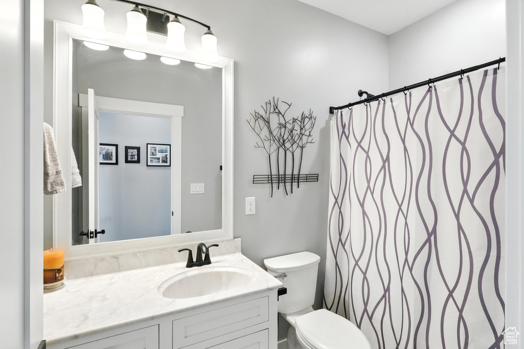 Bathroom with vanity and curtained shower