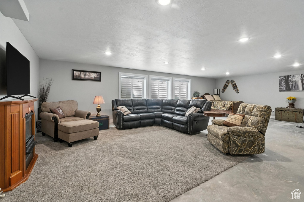 Living area featuring recessed lighting and concrete flooring