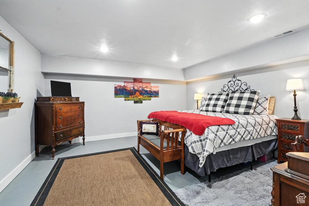 Bedroom featuring recessed lighting and finished concrete flooring