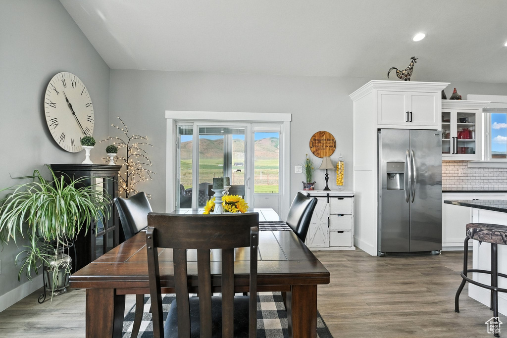 Dining space featuring dark wood-type flooring and recessed lighting
