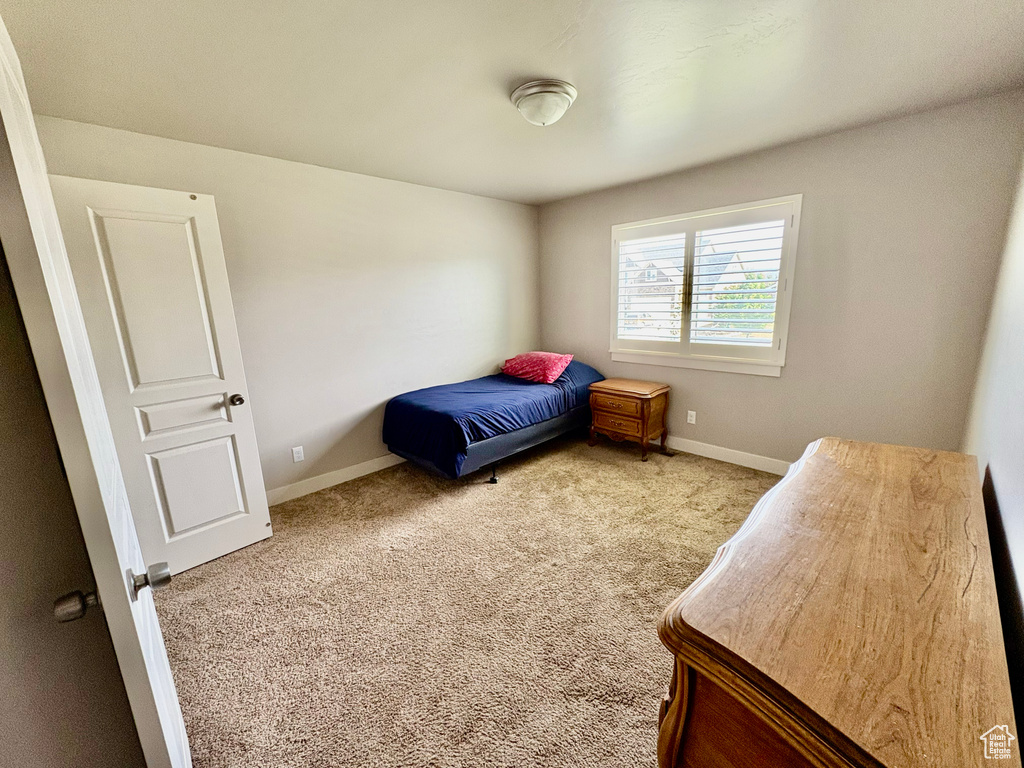 Carpeted bedroom featuring baseboards