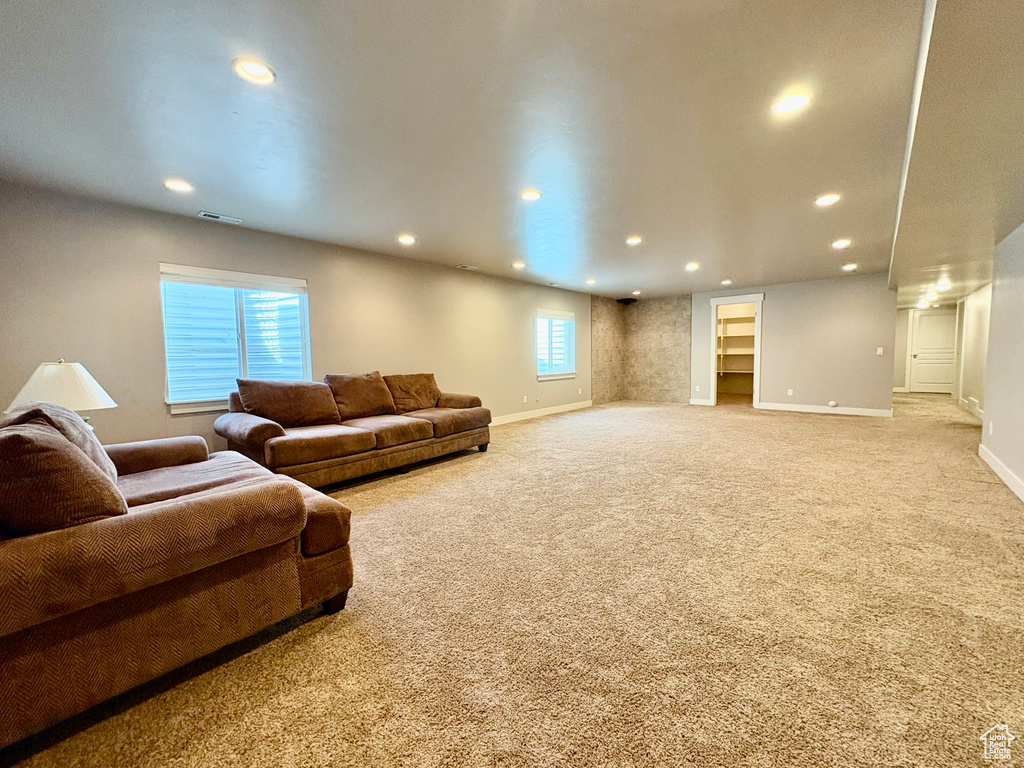 Living area with recessed lighting, carpet, and built in shelves