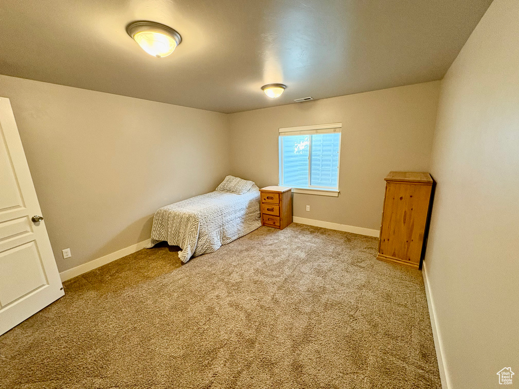 Carpeted bedroom with baseboards