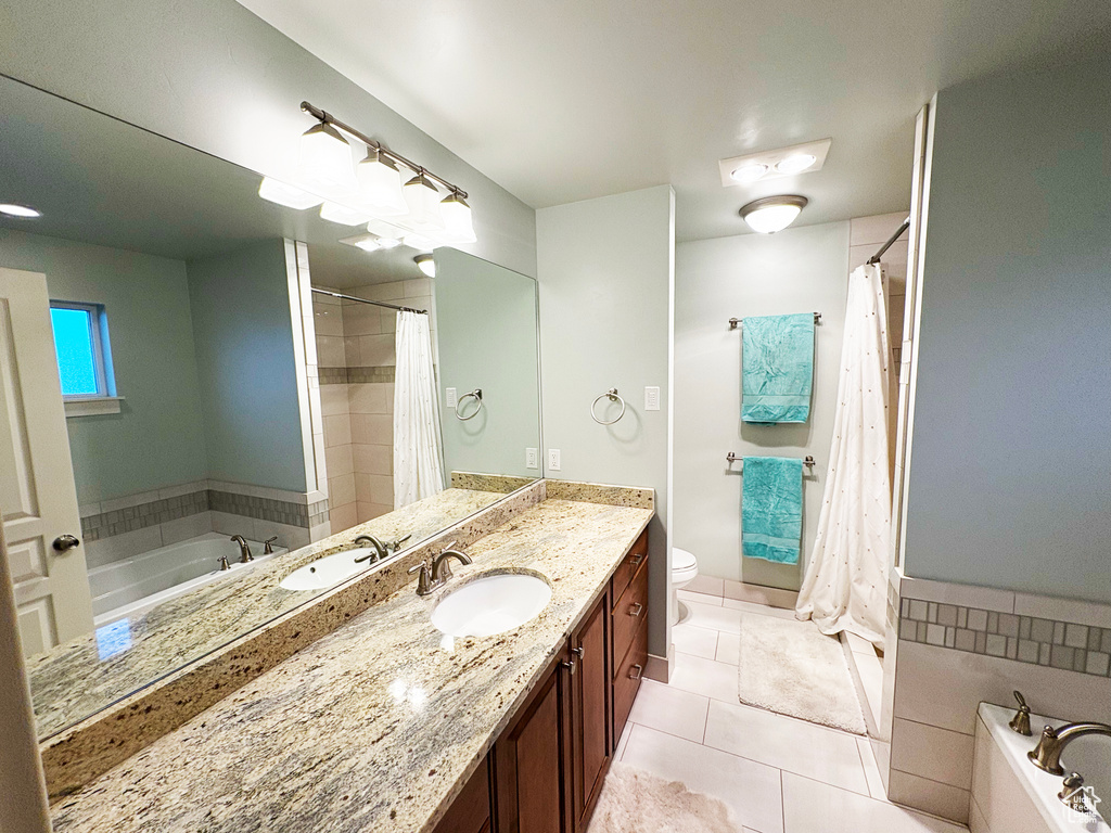 Bathroom featuring vanity, a garden tub, tile patterned flooring, and a shower with shower curtain
