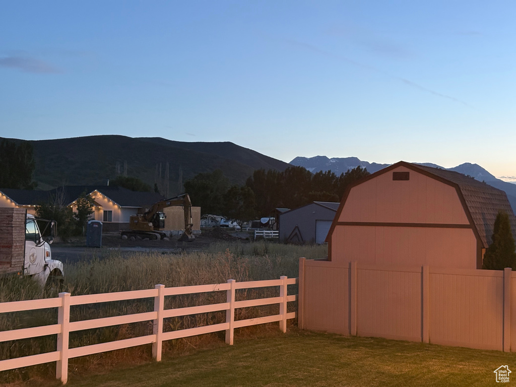 View of yard with a barn, an outdoor structure, and a mountain view