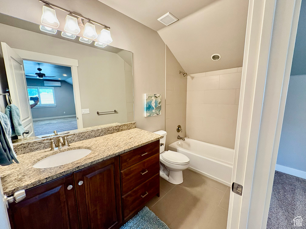 Bathroom featuring vanity, tub / shower combination, ceiling fan, tile patterned floors, and lofted ceiling