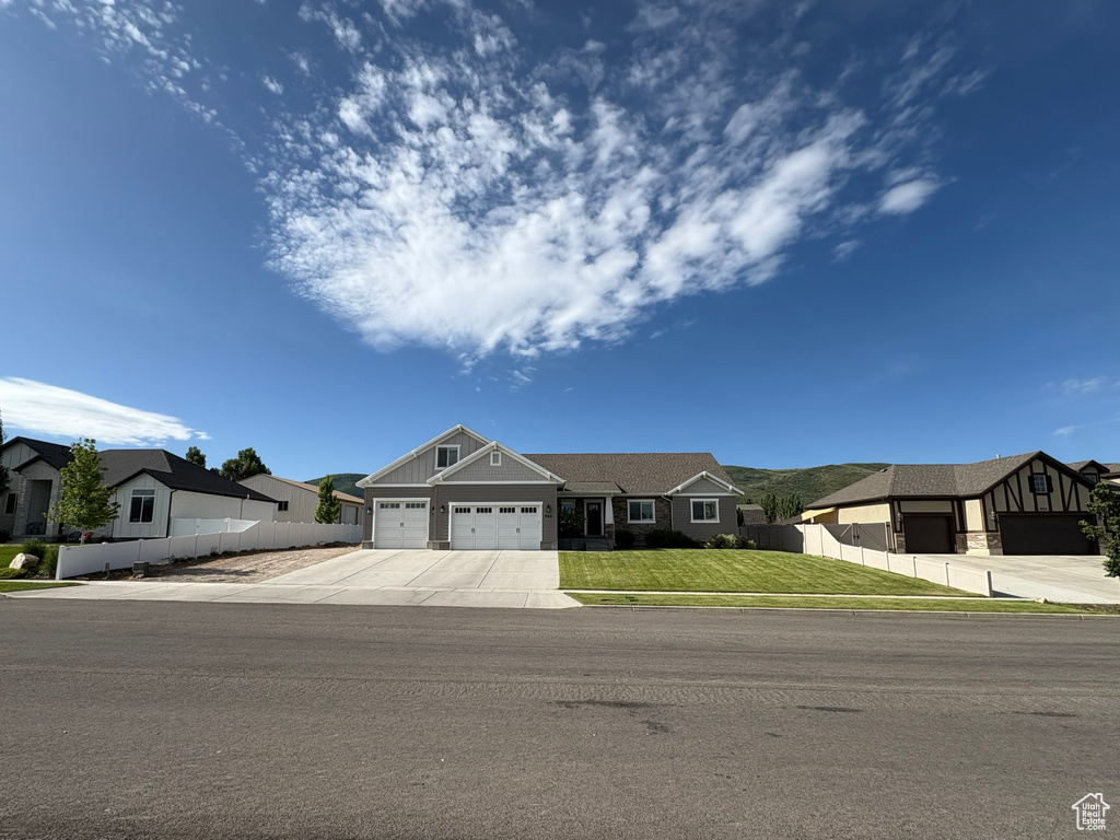 Craftsman-style house with a residential view, an attached garage, and driveway