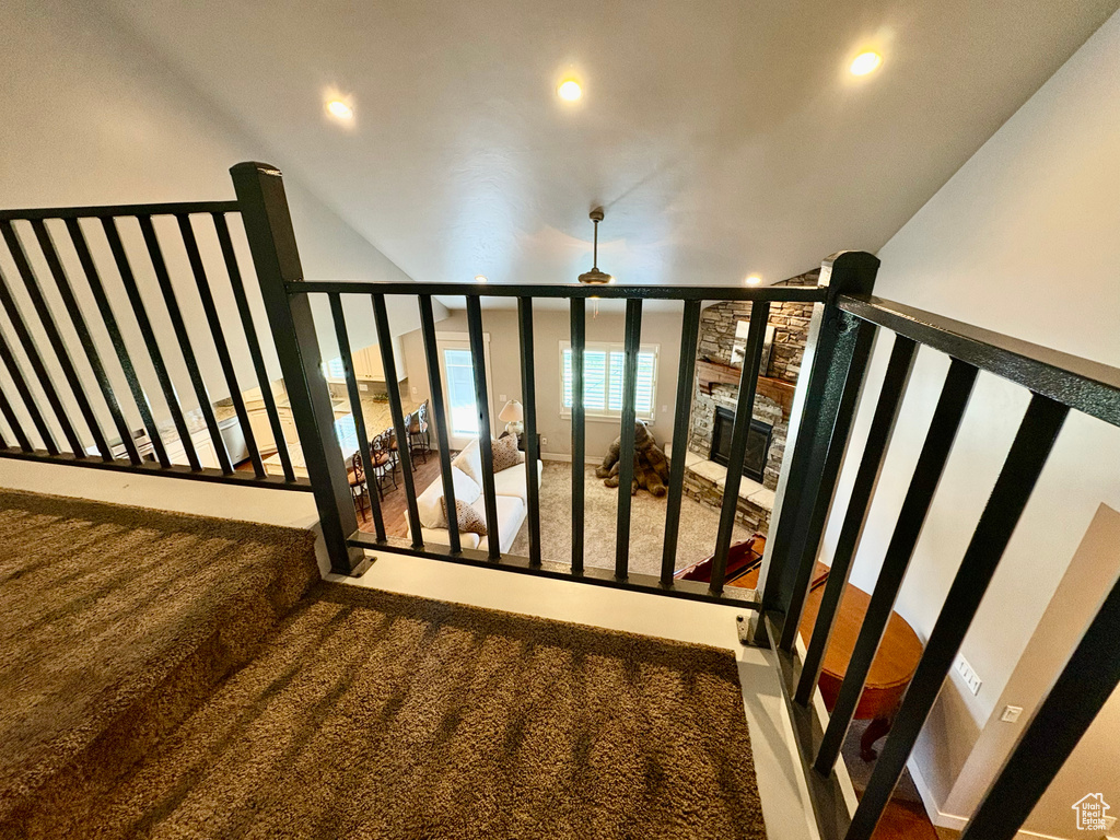 Stairway with carpet, recessed lighting, and a wall of windows